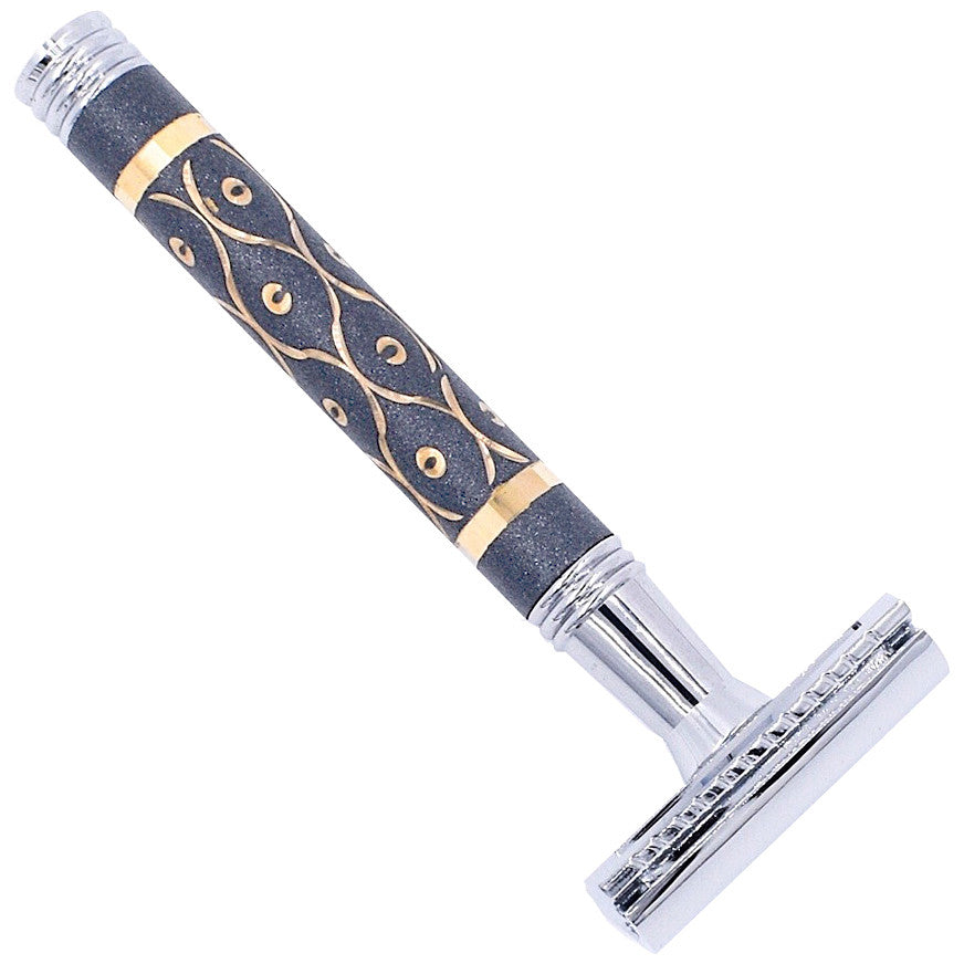 Shaving razor with decorative handle on a white background. Parker 65R safety razor – black and gold heavyweight brass razor.
