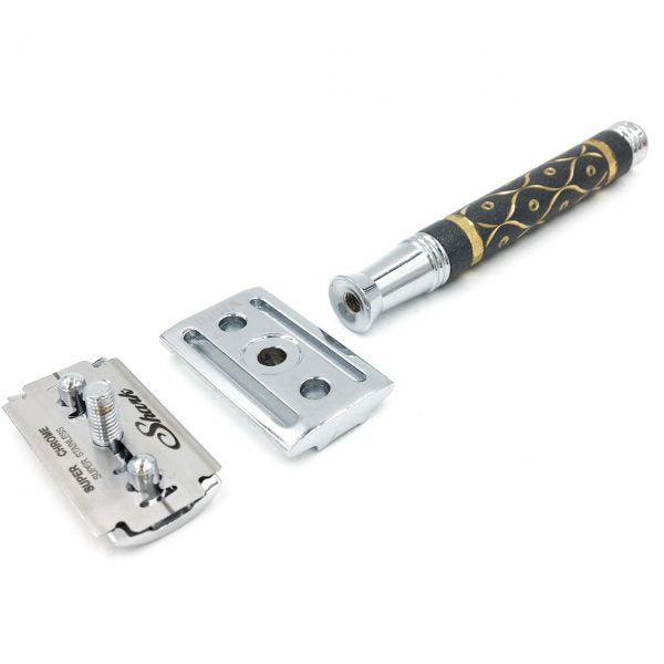 Parker 65R three-piece safety razor disassembled – brass handle, top cap, and base plate with sandstone texture