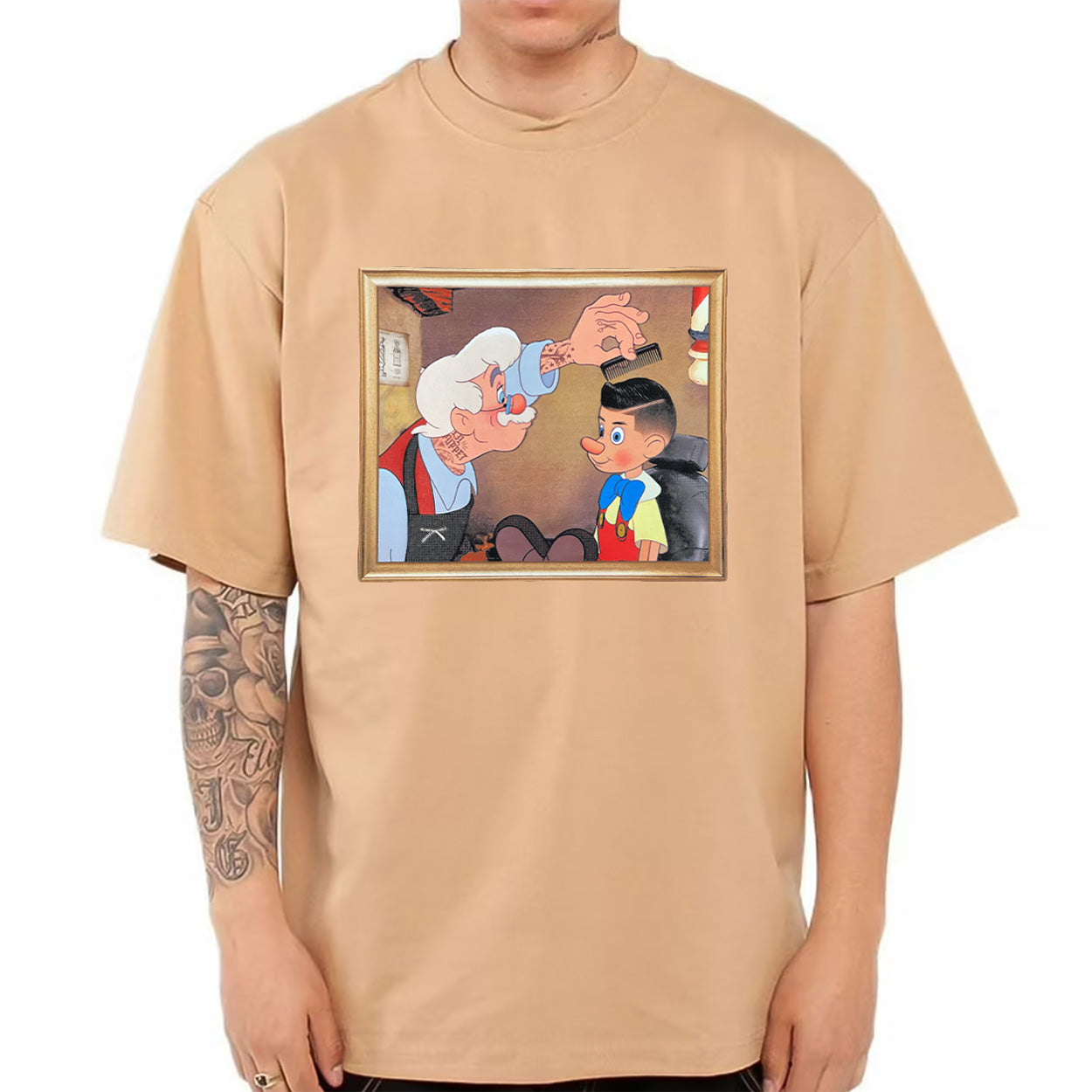 Beige t-shirt with a cartoon graphic on a white background