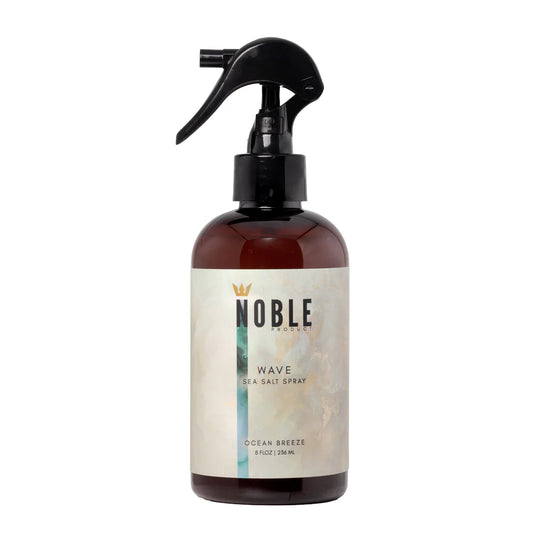 Brown spray bottle with 'Noble' label on a white background. Noble Product Wave Sea Salt Spray 8 oz – lightweight texturizing spray for natural volume and matte finish